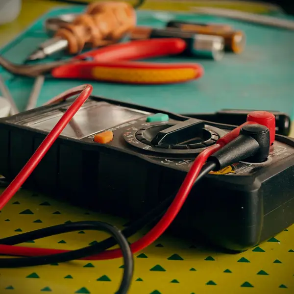 Multimeter and repair tools on a table